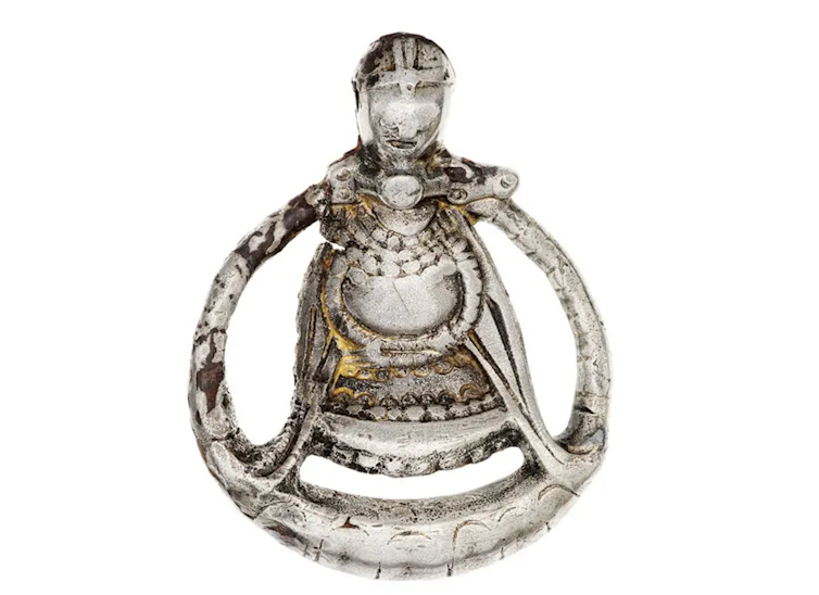 file-20250507-56-8zpzlk A silver pendant showing a pregnant woman